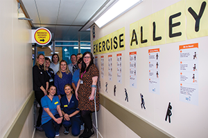 Nurses promoting strength and balance with wall graphics