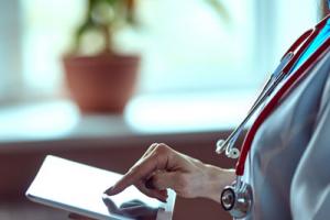 Woman doctor with tablet