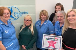Bluebird Care staff with award